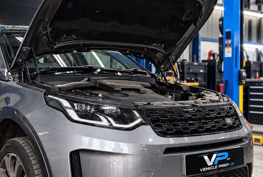 A grey Land Rover Discovery Sport in the workshop during a full service.